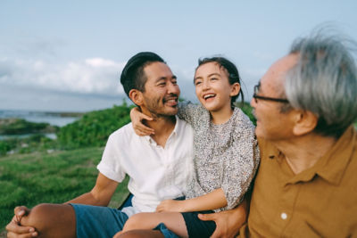 Three generation family having a good time at dusk, Kikai Island of the Amami Islands, Kagoshima, Japan
